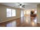 Bright living room with wood floors, kitchen, and sliding glass doors at 21404 N Van Loo Dr, Maricopa, AZ 85138