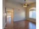 Bright living room with hardwood floors and ceiling fan at 21404 N Van Loo Dr, Maricopa, AZ 85138