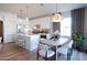 Bright kitchen with an island, dining area, and white cabinetry at 2191 N Iowa St, Chandler, AZ 85225