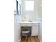 Modern vanity with a white countertop, drawers, and a blue velvet stool at 2191 N Iowa St, Chandler, AZ 85225