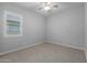 Simple bedroom with carpeted floor and window with shutters at 22852 E Thornton Rd, Queen Creek, AZ 85142