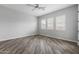 Bright bedroom with wood-look floors and plantation shutters at 22852 E Thornton Rd, Queen Creek, AZ 85142