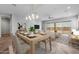 Light-filled dining area with hardwood floors and modern light fixture at 22852 E Thornton Rd, Queen Creek, AZ 85142