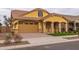 Craftsman style home with a two-car garage, and mature landscaping at 22852 E Thornton Rd, Queen Creek, AZ 85142