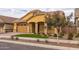 Yellow two-story home with a two-car garage and attractive landscaping at 22852 E Thornton Rd, Queen Creek, AZ 85142