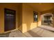 Dark brown front door and neutral colored front porch at 22852 E Thornton Rd, Queen Creek, AZ 85142