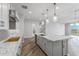 Spacious kitchen island with marble countertop, perfect for casual dining at 22852 E Thornton Rd, Queen Creek, AZ 85142