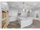 Modern kitchen with curved island, white cabinets, and marble countertops at 22852 E Thornton Rd, Queen Creek, AZ 85142