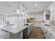 Open concept kitchen with large island, white cabinets, and marble countertops at 22852 E Thornton Rd, Queen Creek, AZ 85142