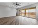 Bright living room with sliding glass doors and hardwood floors at 22852 E Thornton Rd, Queen Creek, AZ 85142