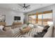 Living room with wood-look floors, a fireplace, and modern furniture at 22852 E Thornton Rd, Queen Creek, AZ 85142