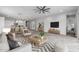 Open living room with kitchen and dining area views, featuring wood-look floors and modern accents at 22852 E Thornton Rd, Queen Creek, AZ 85142