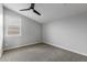 Empty bedroom with grey carpet and ceiling fan at 22878 E Carriage Way, Queen Creek, AZ 85142