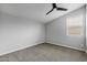 Empty bedroom with grey carpet and ceiling fan at 22878 E Carriage Way, Queen Creek, AZ 85142