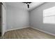 Simple bedroom with wood-look floors and ceiling fan at 22878 E Carriage Way, Queen Creek, AZ 85142