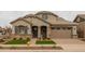 Two-story home with a welcoming front porch and landscaping at 22878 E Carriage Way, Queen Creek, AZ 85142