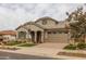 Beautiful home with stone accents, landscaping and a three-car garage at 22878 E Carriage Way, Queen Creek, AZ 85142