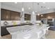 Modern kitchen with granite countertops and dark wood cabinets at 22878 E Carriage Way, Queen Creek, AZ 85142