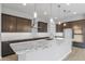 Modern kitchen with granite countertops and dark wood cabinets at 22878 E Carriage Way, Queen Creek, AZ 85142