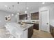 Modern kitchen with granite countertops and dark wood cabinets at 22878 E Carriage Way, Queen Creek, AZ 85142