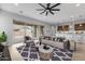 Bright and airy living room with large windows, hardwood floors and modern furniture at 22878 E Carriage Way, Queen Creek, AZ 85142