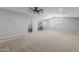 Large loft bedroom with carpeted floor and ceiling fan at 22878 E Carriage Way, Queen Creek, AZ 85142