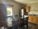 Kitchen with wood cabinets, tile flooring and dining area at 24013 N Mojave Ln, Florence, AZ 85132