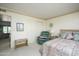 Bedroom with a queen-size bed, built-in closet, and armchair at 2544 S Daisy --, Mesa, AZ 85209