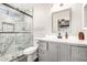 Modern bathroom with gray vanity and marble shower at 3235 W Irma Ln, Phoenix, AZ 85027