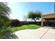 Large backyard with grassy lawn and covered patio at 3267 E Maplewood St, Gilbert, AZ 85297