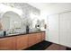 Bathroom with dual vanities, an updated look, and stylish wallpaper at 3267 E Maplewood St, Gilbert, AZ 85297