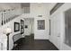 Bright entryway with staircase, bench, and dark hardwood floors at 3267 E Maplewood St, Gilbert, AZ 85297