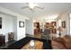 Spacious living room with leather sofas and a view into the kitchen at 3267 E Maplewood St, Gilbert, AZ 85297