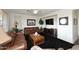 Living room with leather sofas, a coffee table, and a large TV at 3267 E Maplewood St, Gilbert, AZ 85297