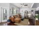 Bright living room, featuring a brown leather couch and a home office space at 3302 N 7Th St # 208, Phoenix, AZ 85014