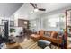 Spacious living room featuring a leather couch and brick accent wall at 3302 N 7Th St # 208, Phoenix, AZ 85014