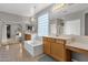 Elegant bathroom with double sinks, a large bathtub, and a glass block window at 3436 E Vaughn Ave, Gilbert, AZ 85234