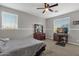 Cozy bedroom with a dresser, desk, and a ceiling fan at 3436 E Vaughn Ave, Gilbert, AZ 85234