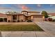 Two-story home with stone accents, large yard, and two-car garage at 3436 E Vaughn Ave, Gilbert, AZ 85234