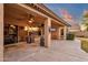 Covered patio with ceiling fan, heater, and large TV at 3436 E Vaughn Ave, Gilbert, AZ 85234