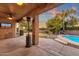 Covered patio with outdoor heater and TV, overlooking the pool at 3436 E Vaughn Ave, Gilbert, AZ 85234