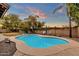 Relaxing kidney-shaped pool with patio furniture and grassy area at 3436 E Vaughn Ave, Gilbert, AZ 85234