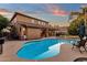 Relaxing kidney-shaped pool in the backyard at sunset at 3436 E Vaughn Ave, Gilbert, AZ 85234