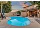 Inviting kidney-shaped pool with patio furniture, ready for summer fun at 3436 E Vaughn Ave, Gilbert, AZ 85234