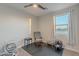 Bedroom with rocking chair, window, and baby items at 3515 N Tewa Cir, Eloy, AZ 85131