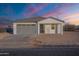 Single story home with gray garage door and front porch at 3515 N Tewa Cir, Eloy, AZ 85131