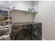 Well-equipped laundry room with washer, dryer, and storage shelves at 3515 N Tewa Cir, Eloy, AZ 85131