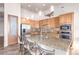 Spacious kitchen featuring granite countertops, stainless steel appliances, and ample wood cabinetry at 36445 N 14Th St, Phoenix, AZ 85086