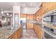 Bright kitchen boasts stainless steel appliances and warm wood cabinets at 36445 N 14Th St, Phoenix, AZ 85086