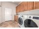 Laundry room with washer, dryer, cabinets, and sink at 36445 N 14Th St, Phoenix, AZ 85086